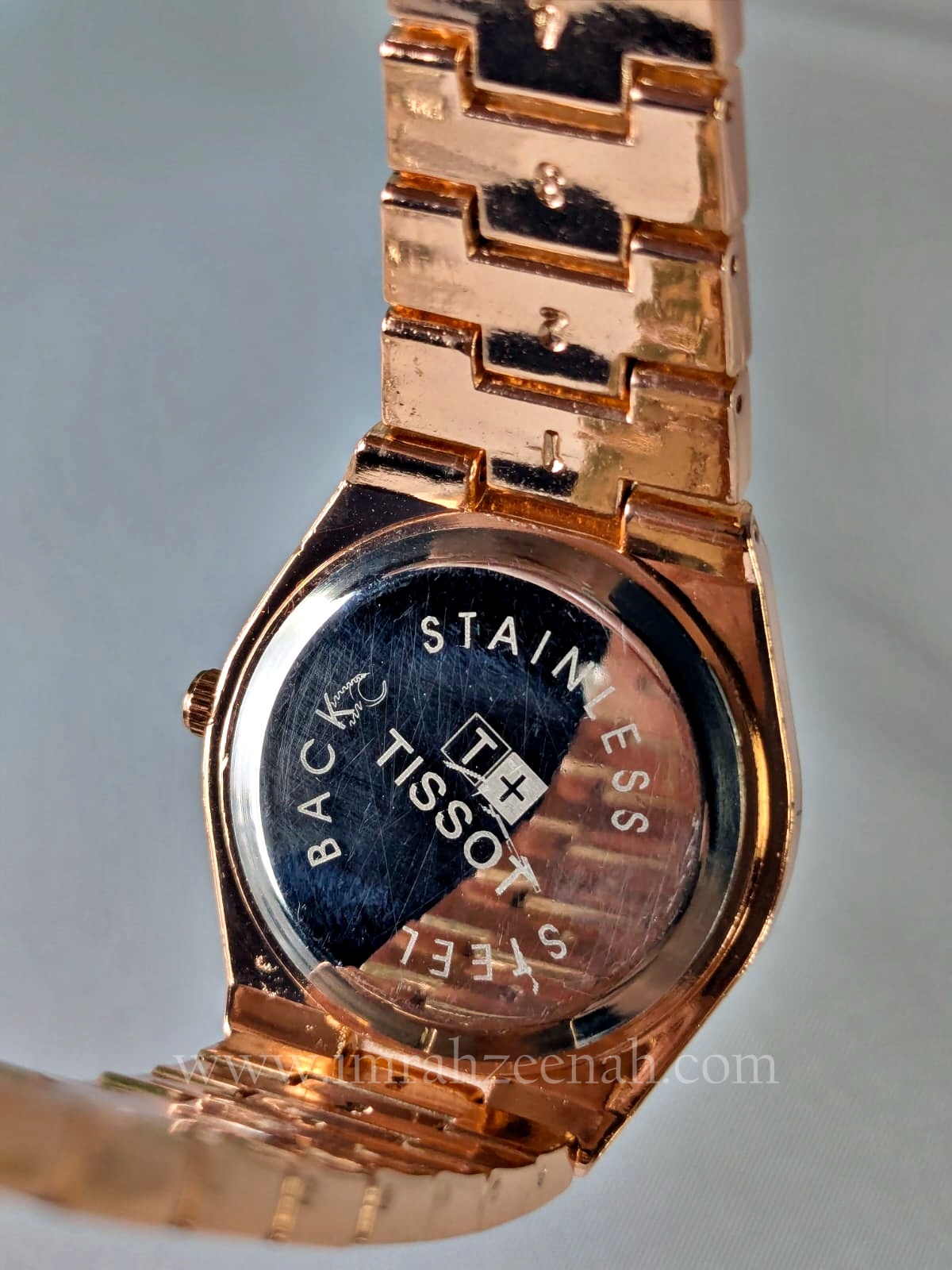 Tissot-style rose gold stainless steel watch with quartz movement and butterfly clasp